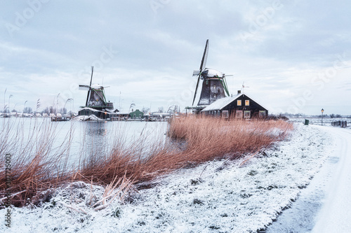 Windmills on the Zaans Schans in winter located on the river De Zaan photo