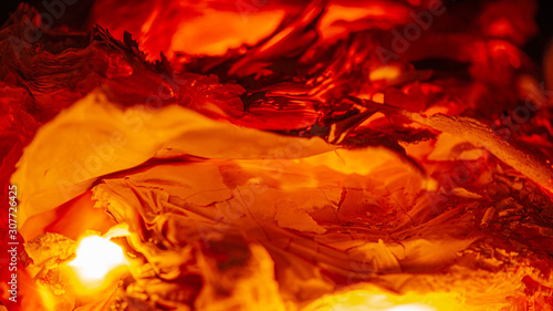 fire burns in the furnace, burning paper, close-up.