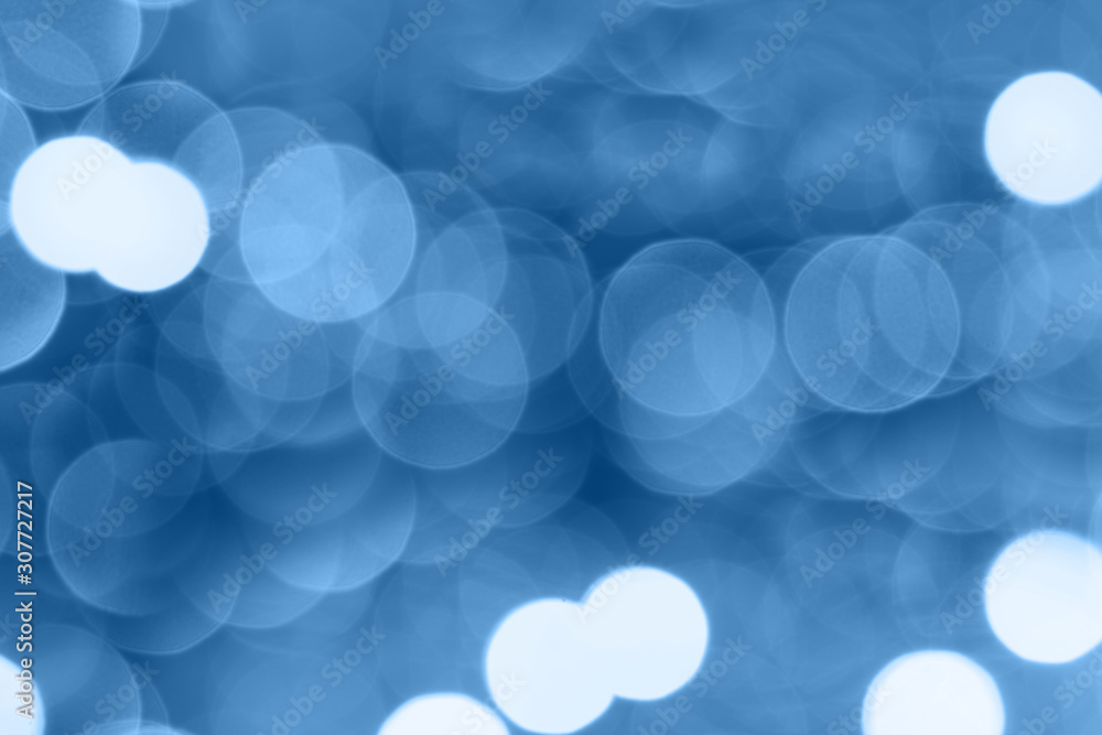 Abstract composition. Blurred photo of glitter with beautiful bokeh in classic blue, color of the year 2020. Defocused light. Abstract composition. Blurred photo of glitter with beautiful bokeh in classic blue, color of the year 2020. Defocused light.