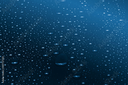 Water drops on classic blue gradient background photo