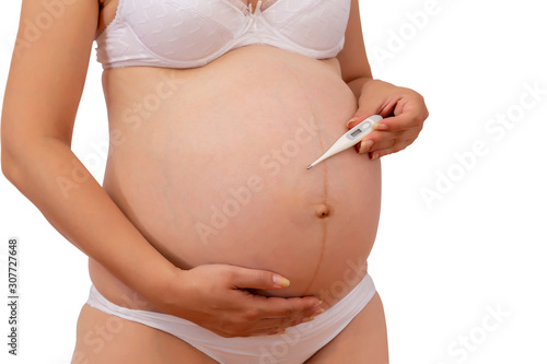 Pregnant woman with a electronic thermometer in hand