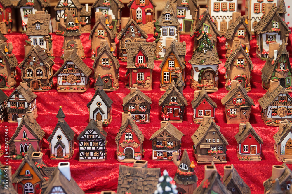 Fototapeta premium Women holding little house toy near pine branches.