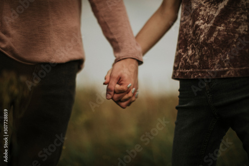 man and woman holding hands
