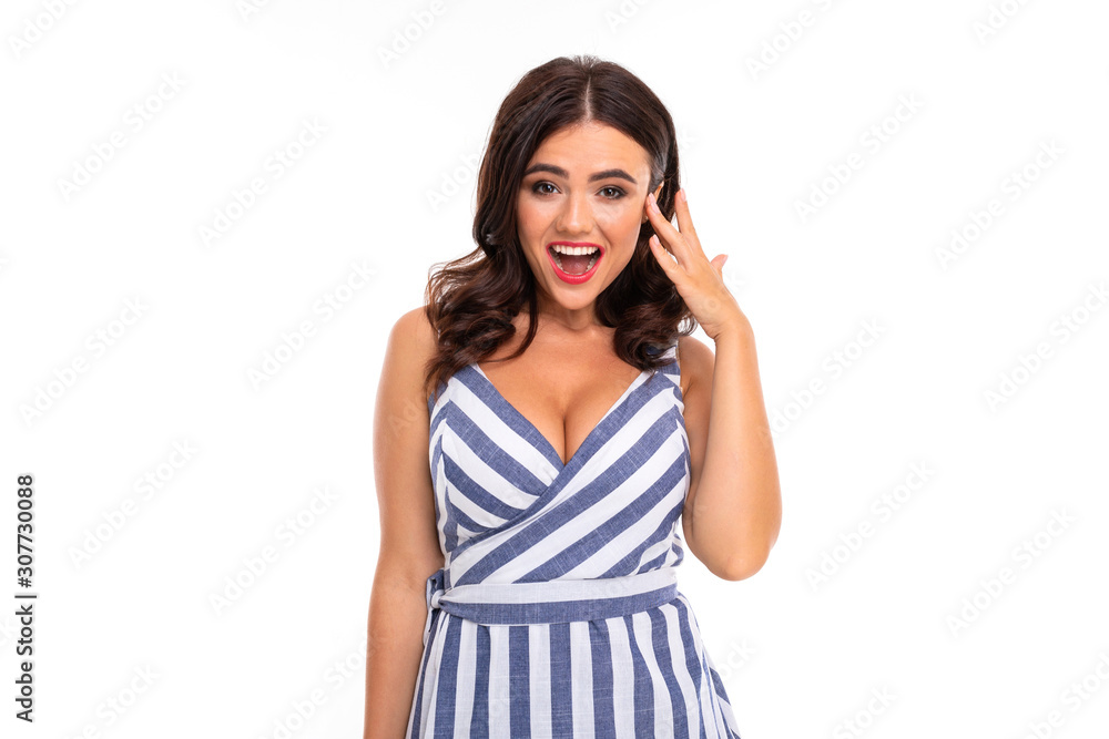 attractive brunette girl with makeup in a striped dress with a neckline on a white background attractive brunette girl with makeup in a striped dress with a neckline on a white background