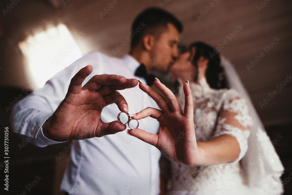 Bride and groom holding rings in hands Bride and groom holding rings in hands