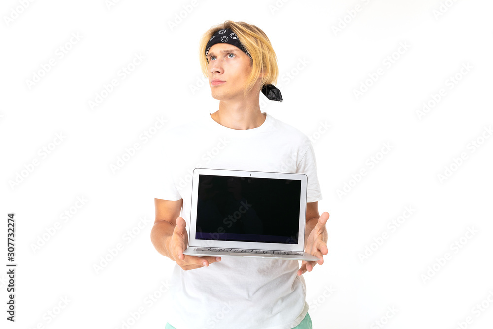Stylish caucasian blonde man shows laptop isolated on white background Stylish caucasian blonde man shows laptop isolated on white background