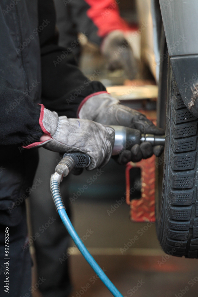 Mechanic checking the pressure of a van tire Mechanic checking the pressure of a van tire