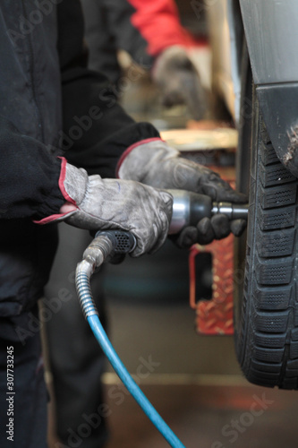 Mechanic checking the pressure of a van tire