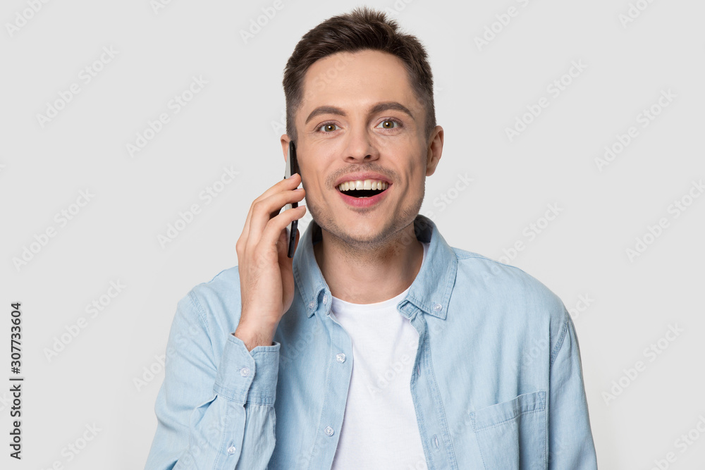 Head shot of happy smiling man talking via smart phone Head shot of happy smiling man talking via smart phone