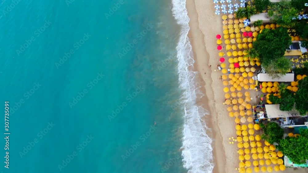 Aerial view of beach in Fortaleza. Luxury resorts and hotels, skyscrapers on the coast line. Amazing sand, bars, restaurants. Side motion of the dron.