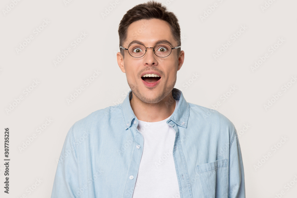 Surprised millennial man with eyes wide open looking at camera Surprised millennial man with eyes wide open looking at camera