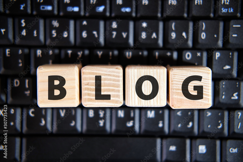 Text of the word BLOG on wooden cubes on a black keyboard Text of the word BLOG on wooden cubes on a black keyboard