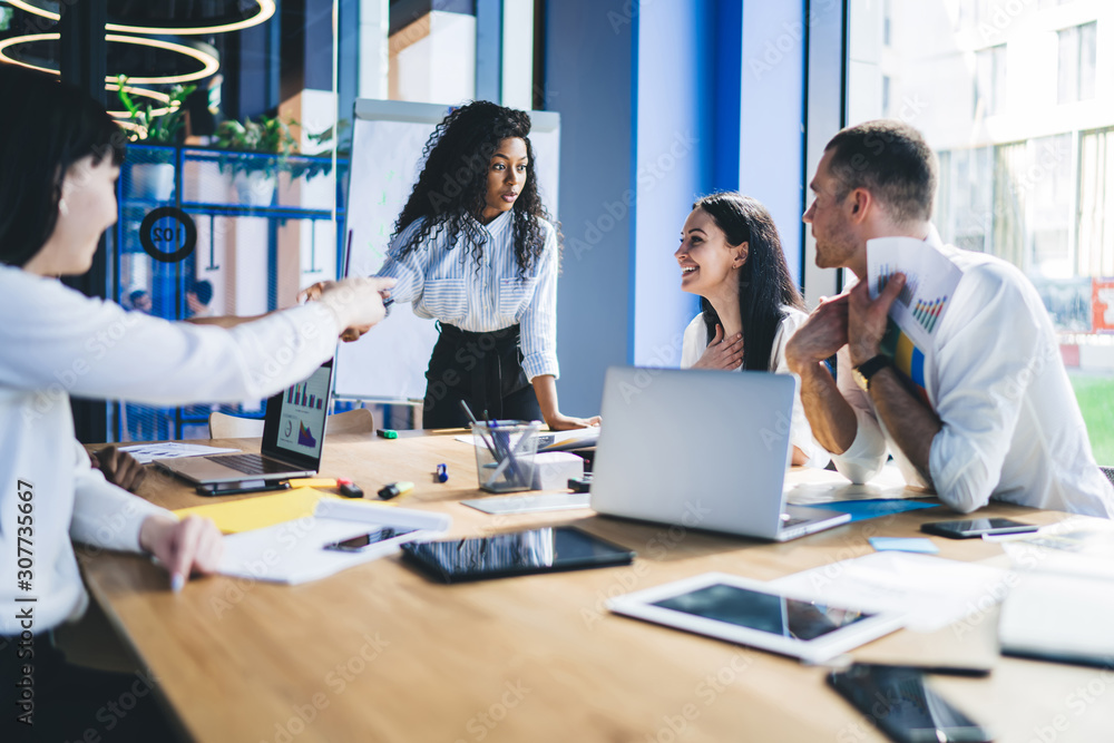 Businesswoman talking to employees on conference