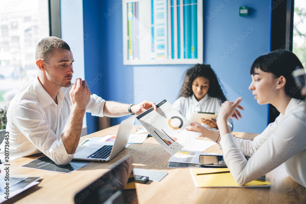 Elegant multiethnic colleagues having discussion in office