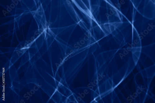 Blue neon smoke abstract. Neon lines. Color of the year concept. Abstract black background. Neon lights texture.