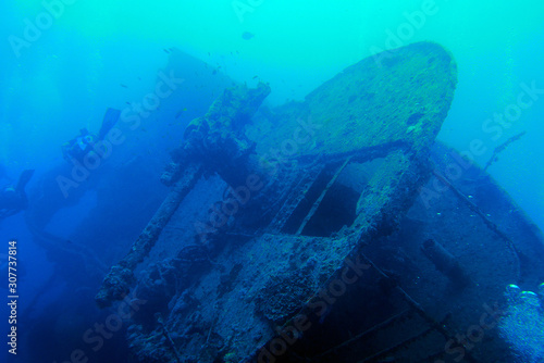 Scuba diving to wreck propellor on bottom of the ocean. © Steven
