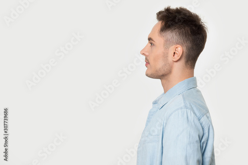 Photography Side view young guy looking at blank empty copy space.