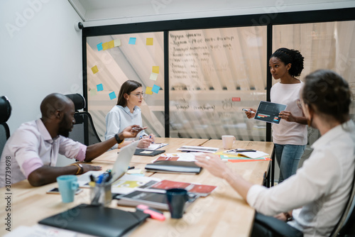 African american office employee creating project with coworker