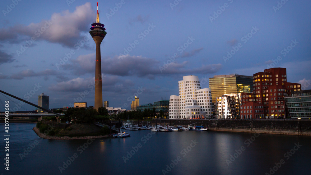 Dusseldorf, Germany - Evening View around the World in Dusseldorf at the Rhine River, the TV Tower and the Iconic Harbor Buildings