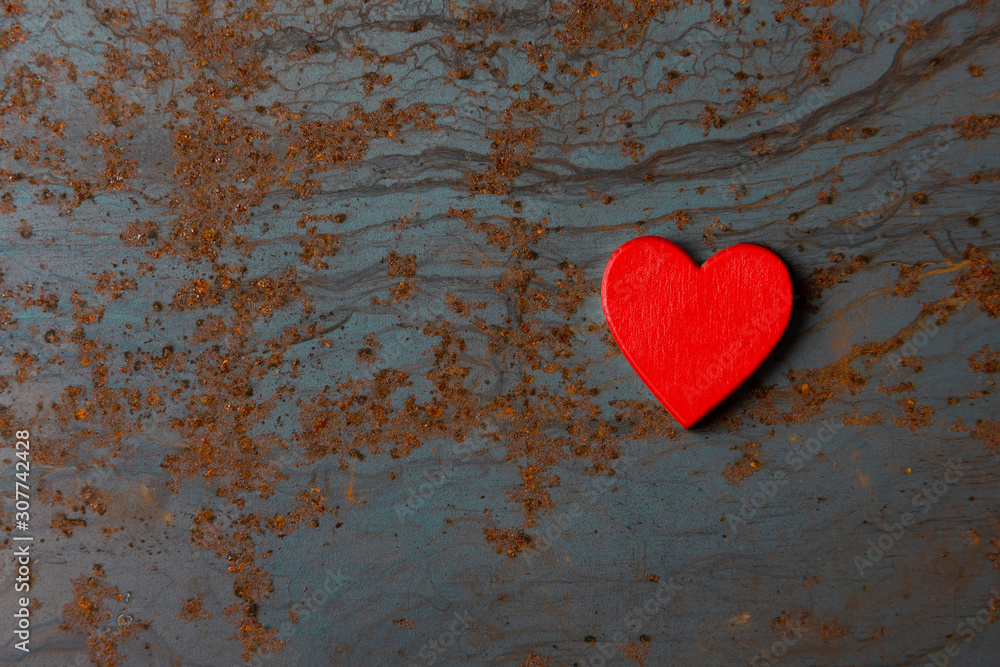 Red wooden heart on a metal background with copy space Red wooden heart on a metal background with copy space