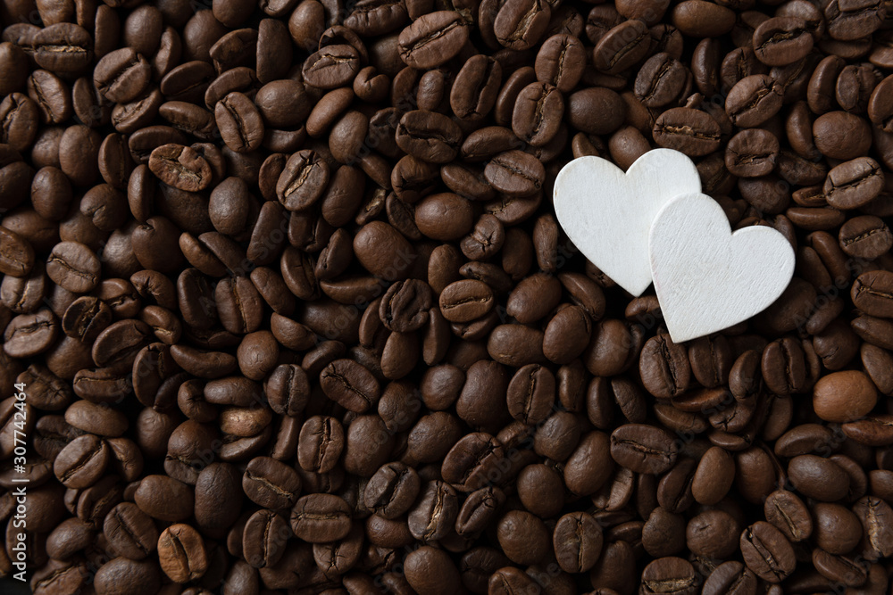 Coffee beans with white hearts, with smoke and copy space Coffee beans with white hearts, with smoke and copy space