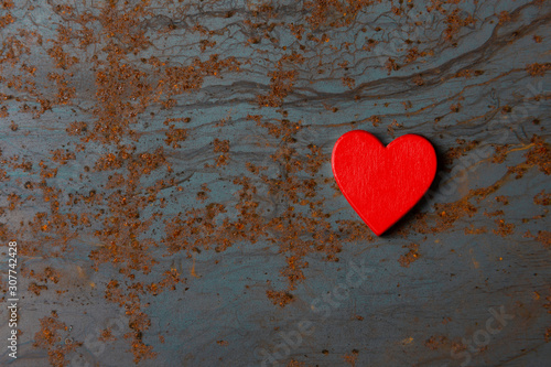 Red wooden heart on a metal background with copy space