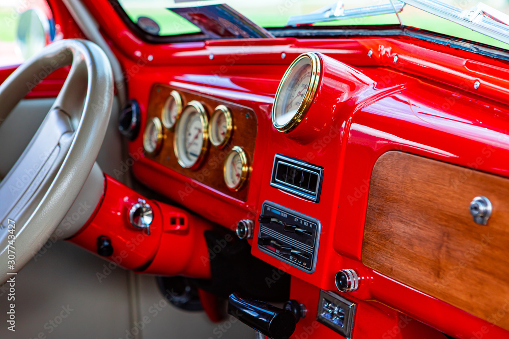 bright red classic antique car Dashboard with wooden and golden parts