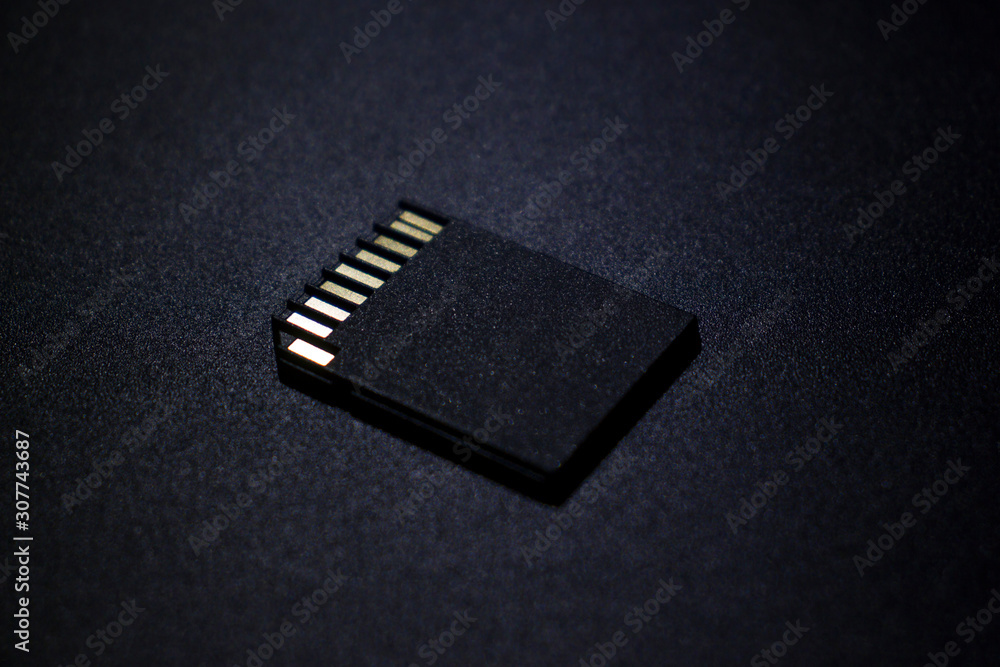 SD card on a dark metal background SD card on a dark metal background