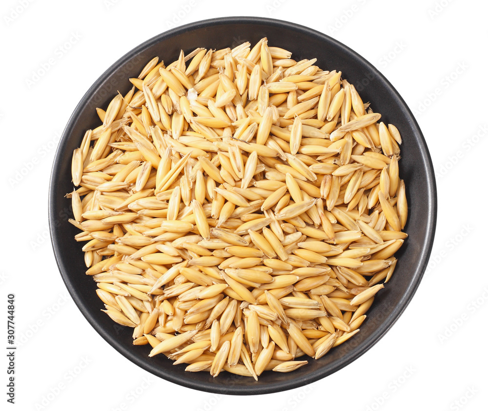 oat seeds in a black plate isolated on white background top view oat seeds in a black plate isolated on white background top view