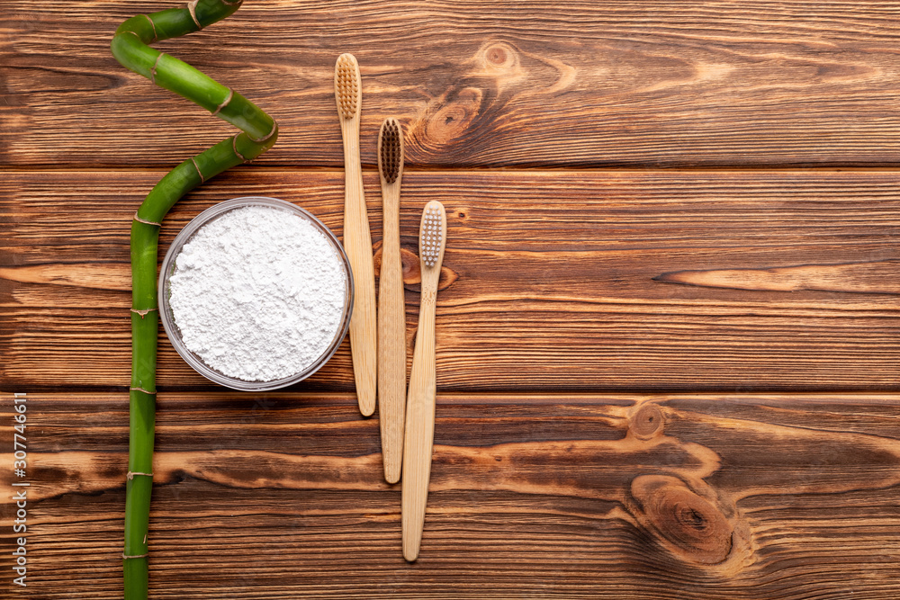 Bamboo toothbrushes, bamboo plant, dentifrice tooth powder on wooden  background. Flat lay copy space. Biodegradable natural bamboo toothbrush. Eco  friendly, Zero waste,Dental care Plastic free concept Stock Photo | Adobe  Stock