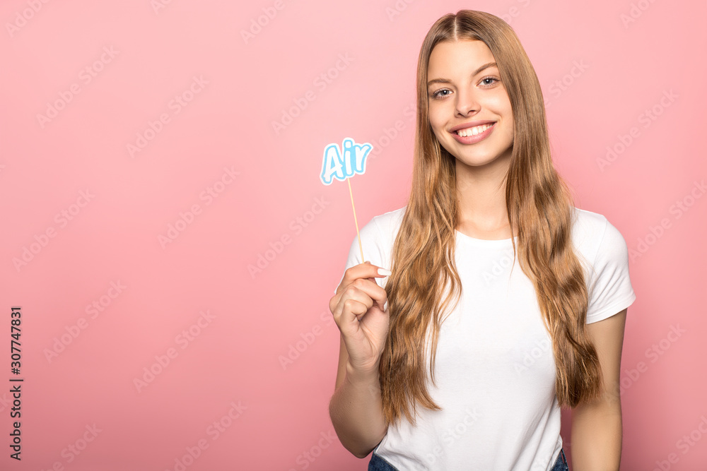 woman holding air lettering on stick isolated on pink woman holding air lettering on stick isolated on pink