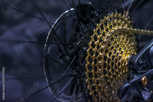 Modern bicycle transmission with gold cassette and many gears. 12 speed bicycle cassete.