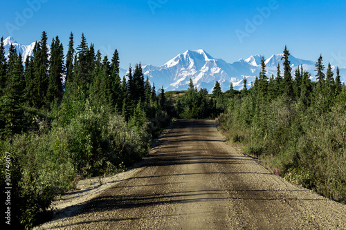 View of the road with mountain in the distance, Driving the Denali highway in Alaska in the summer