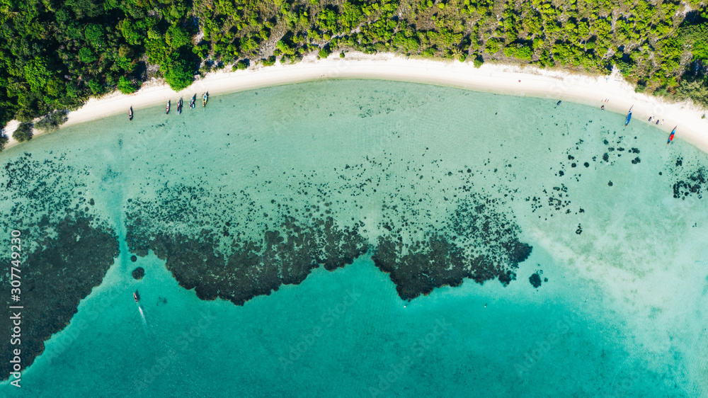 Aerial scenery of picturesque island with crystal azure water and green vegetation.Bird's eye view of paradise beach shoreline, beautiful tourist destination for summer vacations, sport attractions