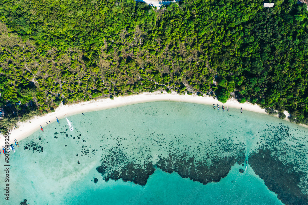 Aerial scenery of picturesque island with crystal azure water and green vegetation.Bird's eye view of paradise beach shoreline, beautiful tourist destination for summer vacations, sport attractions