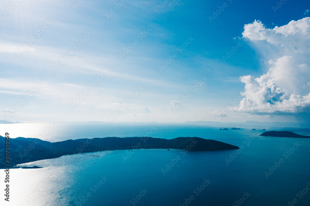 Bird's eye view of picturesque uninhabited islands surrounded by pure nature. Beautiful blue sky with white clouds. Breathtaking scenery landscape with sea