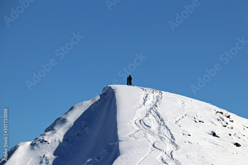 man with snowboard at the top of the snowy mountain photo