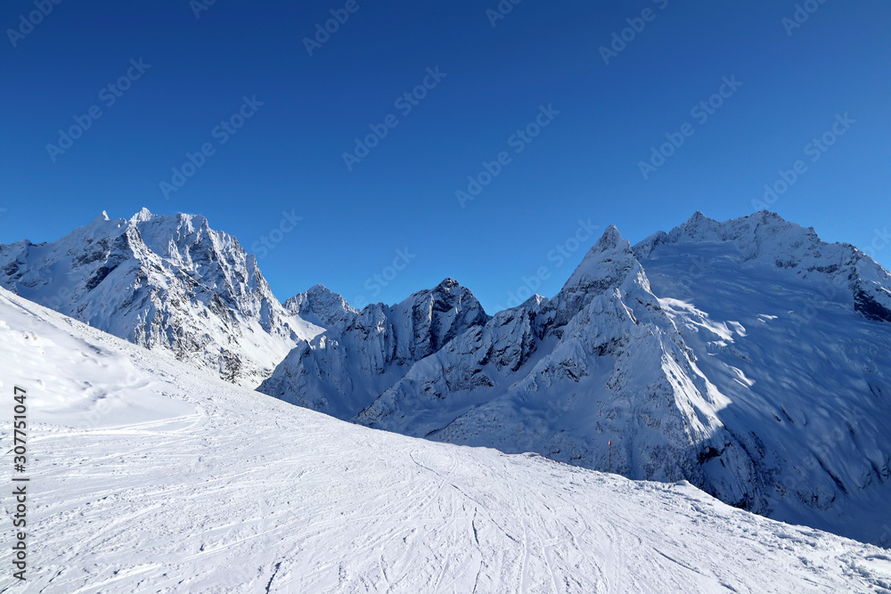 Snowy Mountains peaks and the blue sky Caucasus