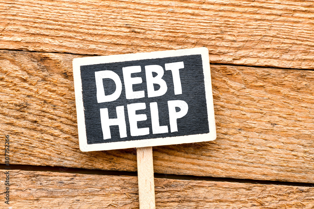 Debt Help text on a small chalk board. View from above. High resolution photo - business concept.