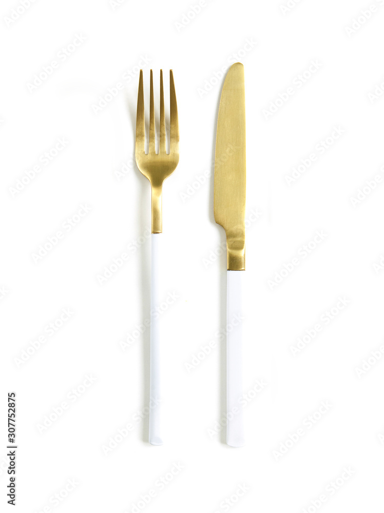 White golden cutlery view from above on a white background. Top view..Knife and fork for a festive table for a wedding, birthday or party. White golden cutlery view from above on a white background. Top view..Knife and fork for a festive table for a wedding, birthday or party.