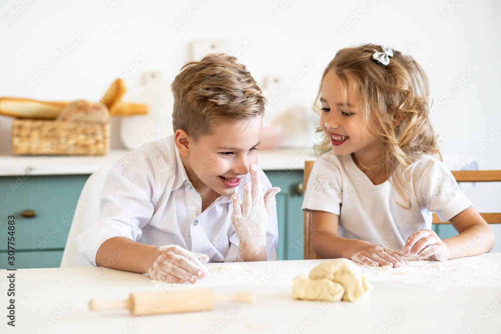 Kids smiling while preparing the cake dough at home Kids smiling while preparing the cake dough at home