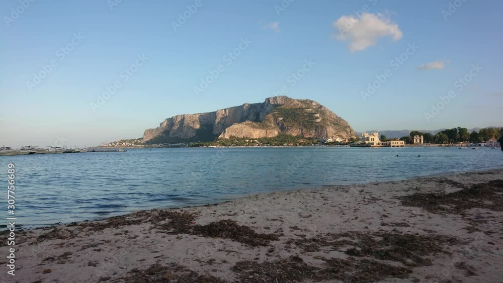 Seashore with mountain and blue sky in the background Seashore with mountain and blue sky in the background