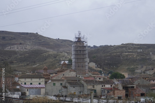vista parcial con torre mudjar de la iglesia  en obras de restauracion navarrete del rio calamocha teruel aragon españa photo