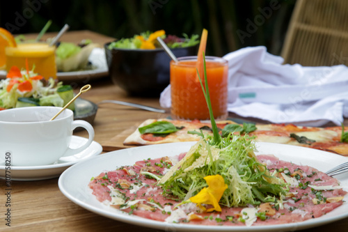 Various healthy vegetarian dishes served on the wooden table