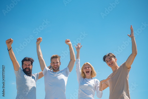 Charming blonde woman standing with boyfriends. Group of close friends smiling looking very happy. Student time and youth concept. Summertime and friendship concept. Friendship huddle happiness.