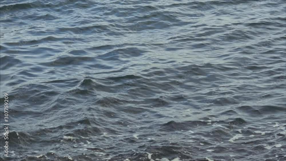 Waves hit the pier and fly on the smallest splashes, surf, Black Sea, slow-motion shot. Waves hit the pier and fly on the smallest splashes, surf, Black Sea, slow-motion shot.