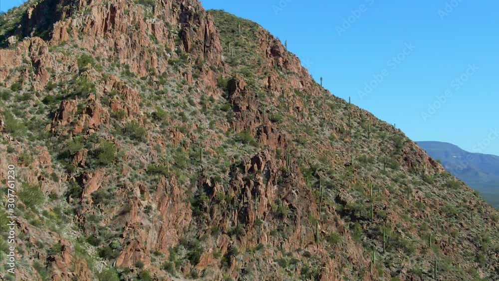 Cinematic aerial looking up cactus on Rocky Mountain side
