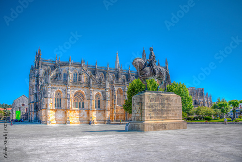 Statue of Nuno Alvares Pereira and Batalha monastery in Portugal photo