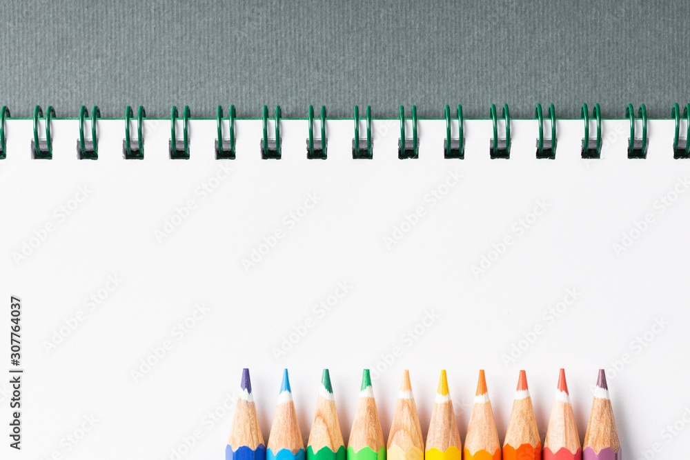 Colored pencils on gray background top view Colored pencils on gray background top view