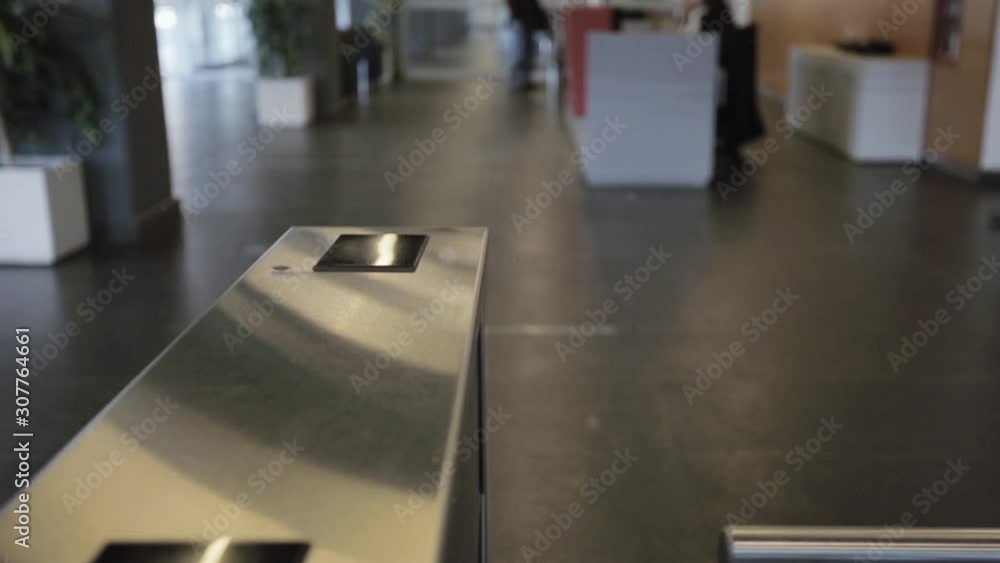 Young Woman Passing Turnstile in the Office. Zoom In Shot. Young Woman Passing Turnstile in the Office. Zoom In Shot.